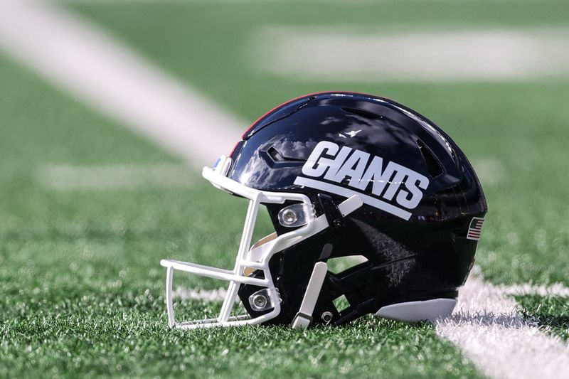 Nov 16, 2025; East Rutherford, New Jersey, USA; A New York Giants helmet rests on the field before the game between the Giants and the Green Bay Packers at MetLife Stadium. Mandatory Credit: Vincent Carchietta-Imagn Images