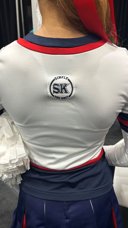 Eastchester's game day cheer team wears a patch on its uniforms designed by Matt Leone that reads "Simply the Best SK" in honor of former Eastchester cheer coach Samantha Kearns, who died of breast cancer in 2024.