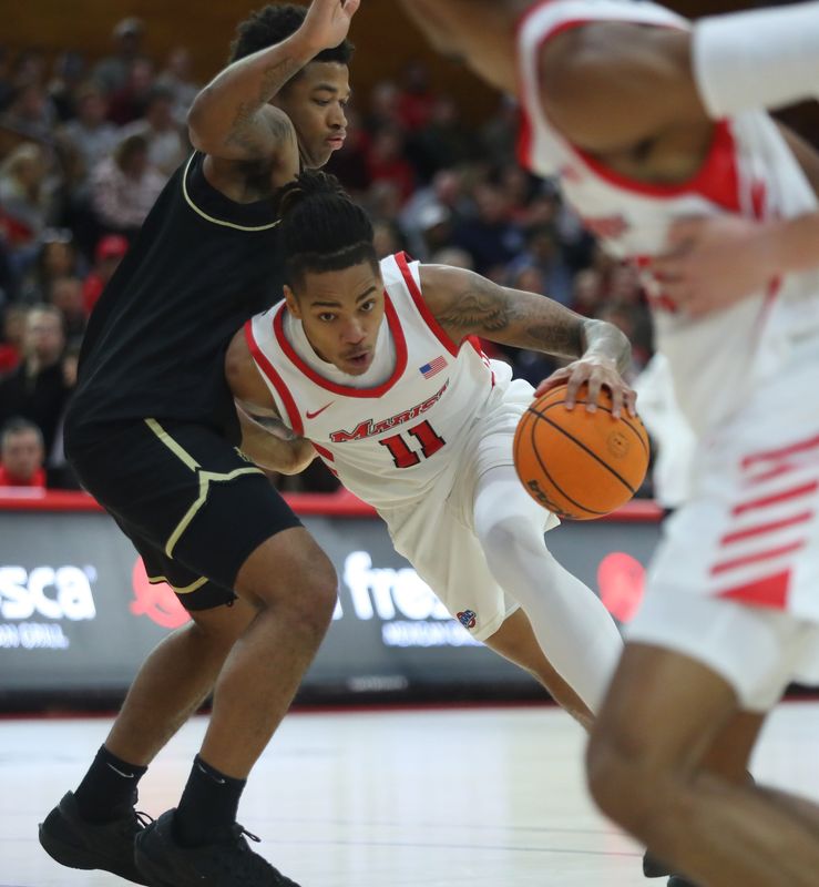 Marist’s Jaden Daughtry leans into Army’s Jacen Holloway during their game on November 21, 2025.