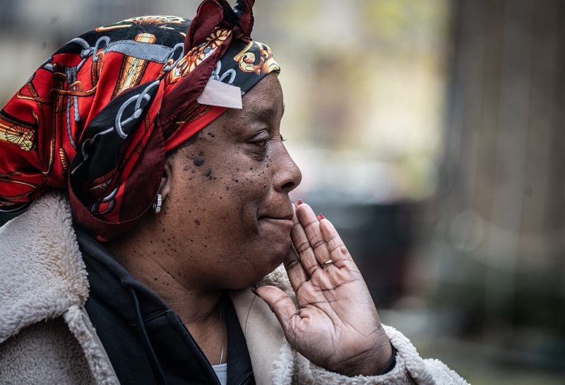 Tammy Harper, a resident of 30 Cottage Ave. in Mount Vernon looks at the severely damaged apartment building after an overnight fire Nov 23, 2025. The fire displaced all residents in the building. No serious injuries were reported in the fire, which destroyed the upper floors of the building.