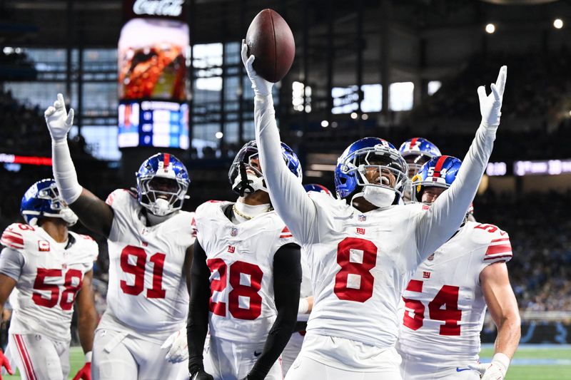 Nov 23, 2025; Detroit, Michigan, USA; New York Giants safety Jevon Holland (8) celebrates an interception in the third quarter against the Detroit Lions at Ford Field. Mandatory Credit: Lon Horwedel-Imagn Images