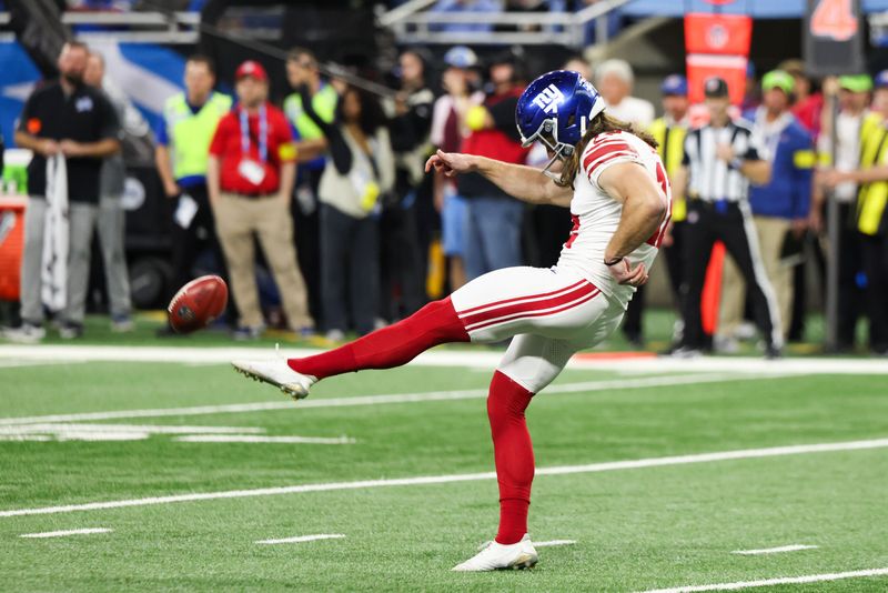 Nov 23, 2025; Detroit, Michigan, USA; New York Giants punter Jamie Gillan (12) kicks the ball in the second quarter against the Detroit Lions at Ford Field. Mandatory Credit: David Reginek-Imagn Images