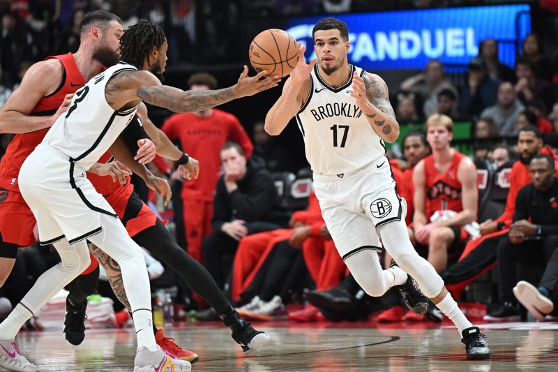 Nov 23, 2025; Toronto, Ontario, CAN; Brooklyn Nets forward Michael Porter Jr. (17) takes the ball from center Nic Claxton (33) in the second half against the Toronto Raptors at Scotiabank Arena. Mandatory Credit: Dan Hamilton-Imagn Images