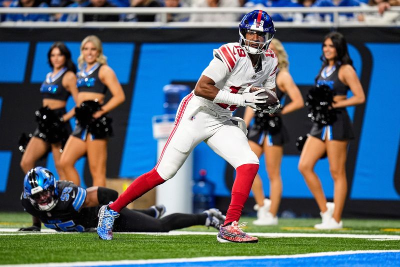 New York Giants quarterback Jameis Winston (19) makes a catch against Detroit Lions linebacker Derrick Barnes (55) during the second half at Ford Field in Detroit on Sunday, Nov. 23, 2025.