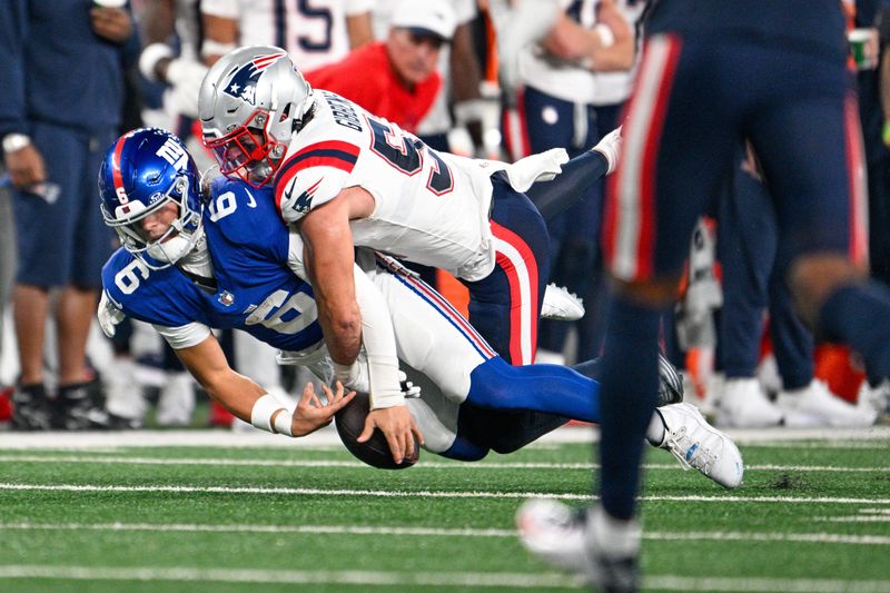 Aug 21, 2025; East Rutherford, New Jersey, USA; New England Patriots linebacker Jack Gibbens (51) tackles for a fumble against New York Giants quarterback Jaxson Dart (6) during the first quarter at MetLife Stadium. Mandatory Credit: Mark Smith-Imagn Images