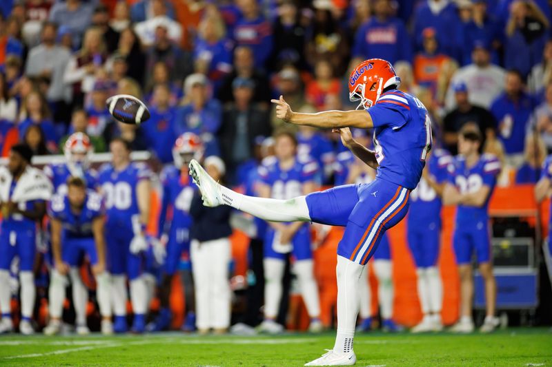 Nov 29, 2025; Gainesville, Florida, USA; Florida Gators kicker Tommy Doman (19) punts against the Florida State Seminoles during the second half at Ben Hill Griffin Stadium. Mandatory Credit: Matt Pendleton-Imagn Images