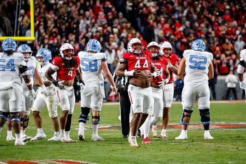 Nov 29, 2025; Raleigh, North Carolina, USA; NC State Wolfpack defensive tackle Brandon Cleveland (44) reacts to his tackle during the first half of the game against North Carolina Tar Heels at Carter-Finley Stadium. Mandatory Credit: Jaylynn Nash-Imagn Images