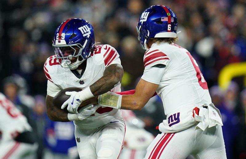 Dec 1, 2025; Foxborough, Massachusetts, USA; New York Giants quarterback Jaxson Dart (6) hands the ball off to New York Giants running back Tyrone Tracy Jr. (29) during the first quarter against the New England Patriots at Gillette Stadium. Mandatory Credit: David Butler II-Imagn Images