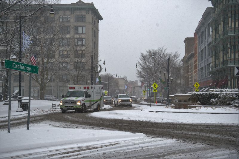 Despite the snow essential workers and residents are out shoveling, delivering mail and out for a winter stroll on Dec. 2, 2025.