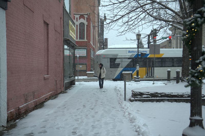 Despite the snow essential workers and residents are out shoveling, delivering mail and out for a winter stroll on Dec. 2, 2025.