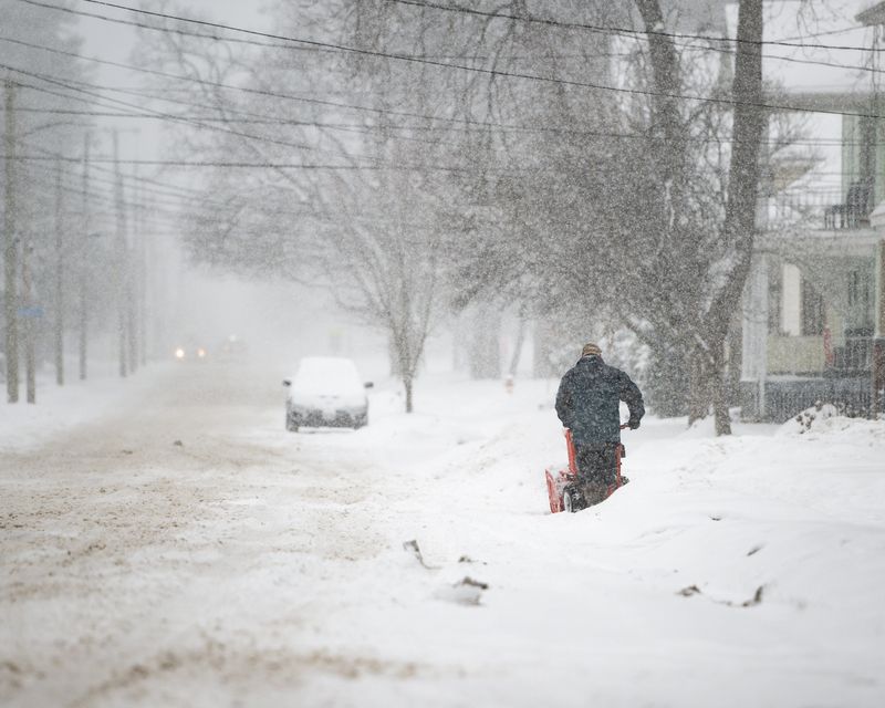 A driveway gets cleared in Utica, NY during widespread snowfall from a nor’easter on Tuesday, December 2, 2025.