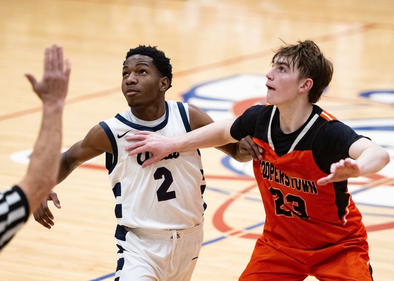 Utica’s John Linen and Cooperstown’s Miles Nelen battle for possession at Utica Academy of Science on Thursday, December 4, 2025.