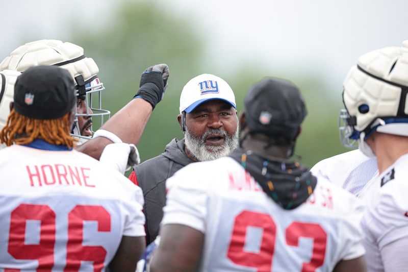 Jul 24, 2024; East Rutherford, NJ, USA; New York Giants assistant defensive line coach Bryan Cox talks with players during training camp at Quest Diagnostics Training Facility. Mandatory Credit: Vincent Carchietta-USA TODAY Sports