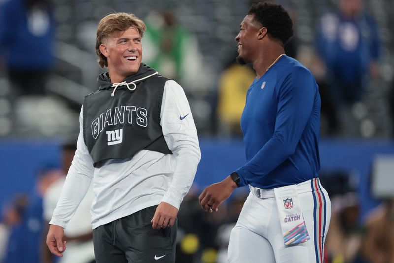 Oct 9, 2025; East Rutherford, New Jersey, USA; New York Giants quarterback Jaxson Dart, left, and quarterback Jameis Winston, right, on the field before the game against the Philadelphia Eagles at MetLife Stadium. Mandatory Credit: Vincent Carchietta-Imagn Images