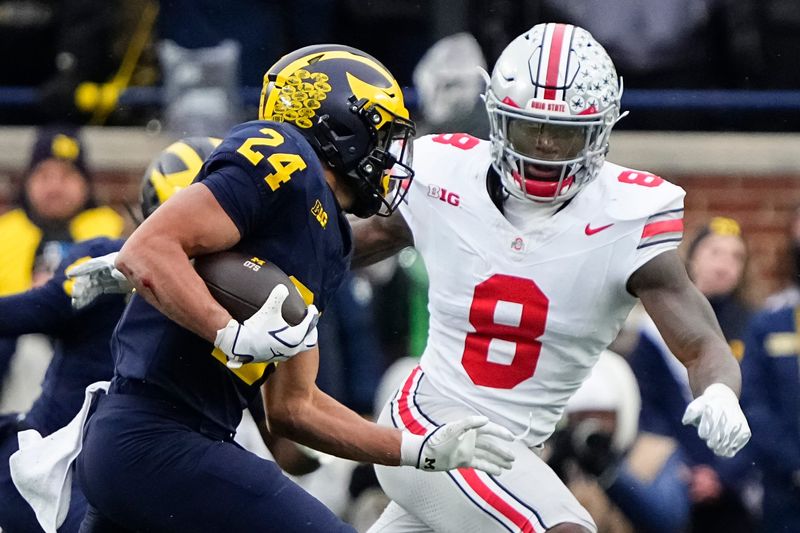 Ohio State Buckeyes linebacker Arvell Reese (8) pursues Michigan Wolverines running back Bryson Kuzdzal (24) during the NCAA football game at Michigan Stadium in Ann Arbor, Mich. on Nov. 29, 2025. Ohio State won 27-9.