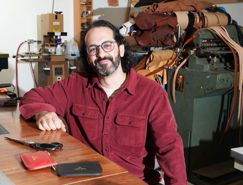 Matt Demeo, founder of handcrafted leather goods company Mateo Mattia, in his New Rochelle studio Dec. 9, 2025. Demeo, 36, founded the company in 2013 after studying fashion at FIT in New York City. Bags, wallets and belts are among the handcrafted leather accessories he makes.