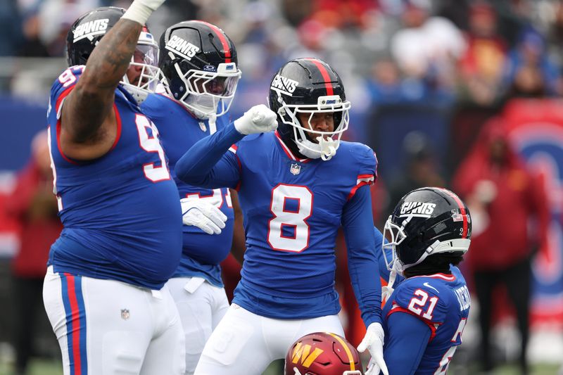 Dec 14, 2025; East Rutherford, New Jersey, USA; New York Giants safety Jevon Holland (8) reacts after defensive stop during the first quarter against the Washington Commanders at MetLife Stadium. Mandatory Credit: Vincent Carchietta-Imagn Images
