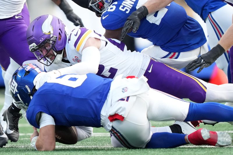 Dec 21, 2025; East Rutherford, New Jersey, USA; Minnesota Vikings free safety Harrison Smith (22) sacks New York Giants quarterback Jaxson Dart (6) during the first half at MetLife Stadium. Mandatory Credit: Robert Deutsch-Imagn Images