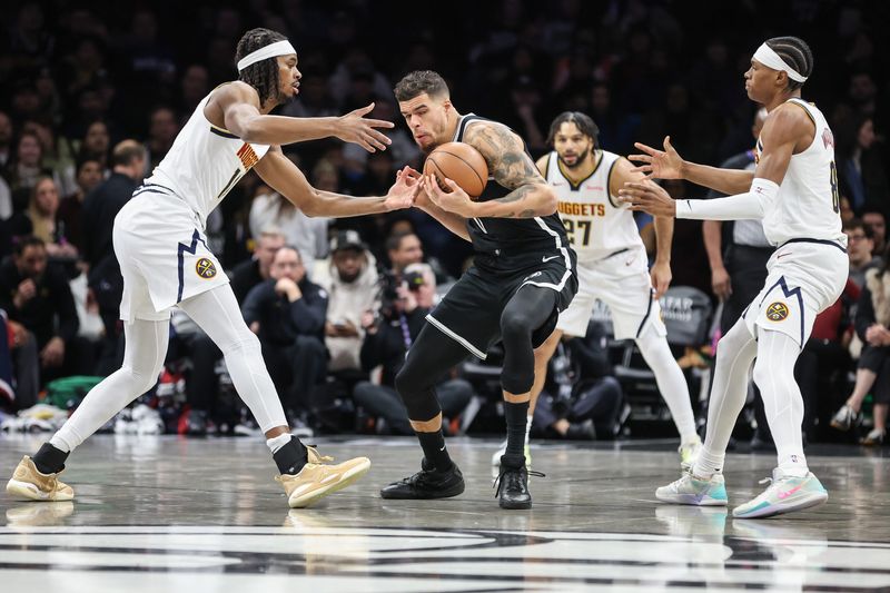 Jan 4, 2026; Brooklyn, New York, USA; Brooklyn Nets forward Michael Porter Jr. (17) is double teammed by Denver Nuggets forward Daron Holmes II (14) and guard Peyton Watson (8) in the first quarter at Barclays Center. Mandatory Credit: Wendell Cruz-Imagn Images