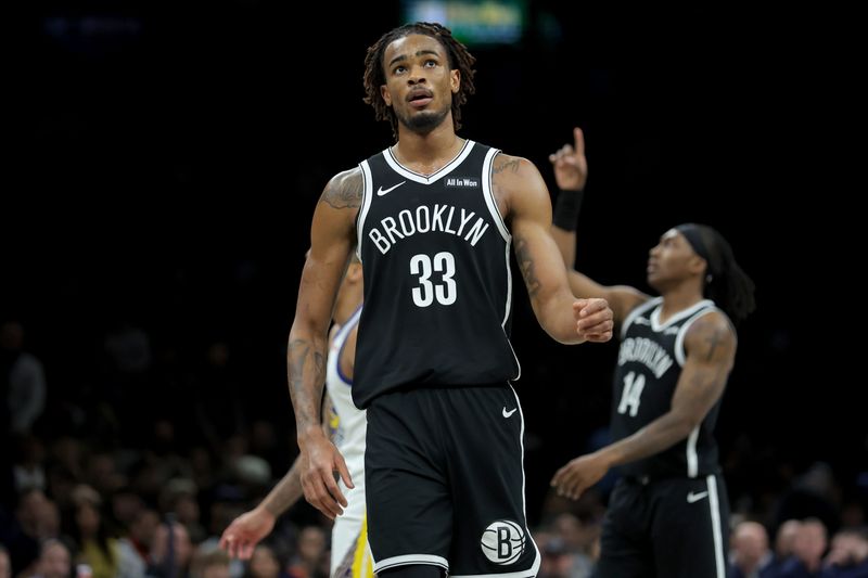Dec 29, 2025; Brooklyn, New York, USA; Brooklyn Nets center Nic Claxton (33) reacts during the fourth quarter against the Golden State Warriors at Barclays Center. Mandatory Credit: Brad Penner-Imagn Images