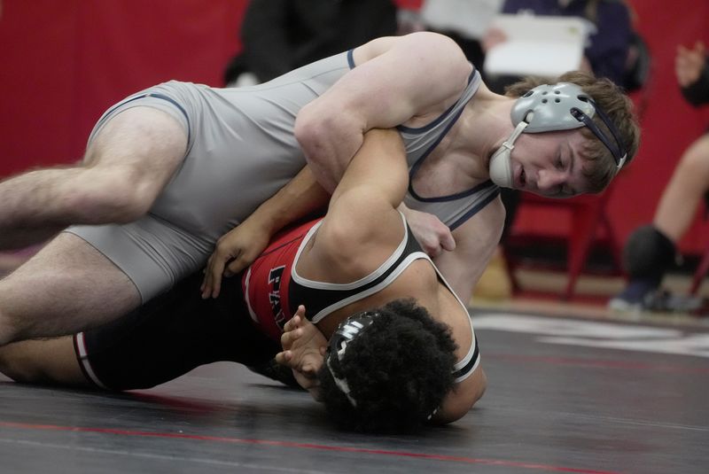 Samson Mckissick Staley of Pittsford defeats Noah Harley of Penfield in their 150-pound match at Penfield High School.