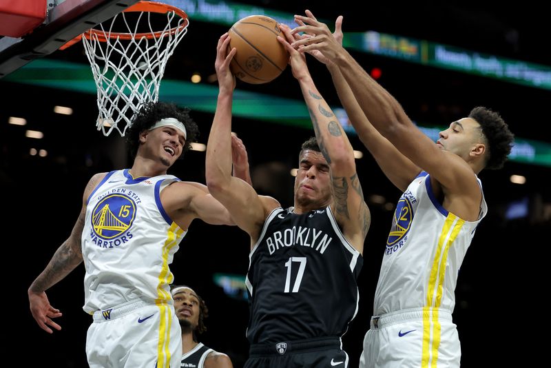 Dec 29, 2025; Brooklyn, New York, USA; Brooklyn Nets forward Michael Porter Jr. (17) grabs a rebound against Golden State Warriors forwards Gui Santos (15) and Trayce Jackson-Davis (32) during the first quarter at Barclays Center. Mandatory Credit: Brad Penner-Imagn Images