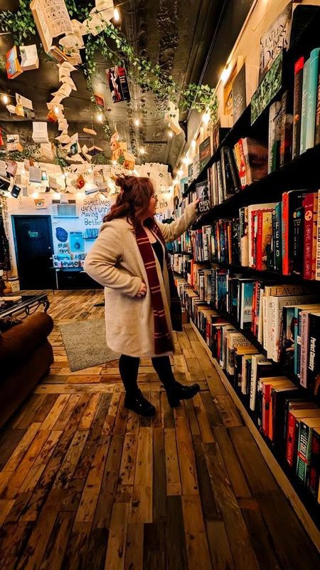 An Athenix Books & Brews customer enjoys the fantasy decor, shelves of new, used books at the new bookstore, opening Jan. 2 on E. Main St., Little Falls