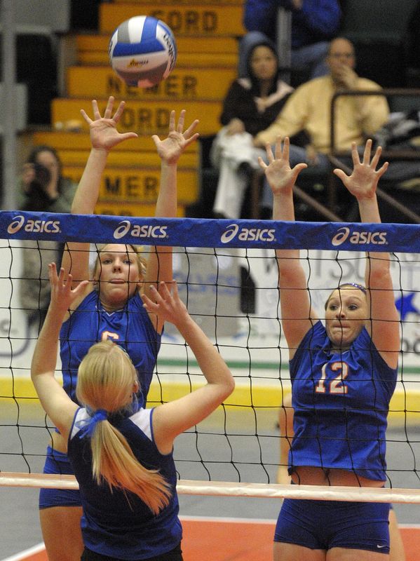 Edison players Jaime Snyder, left, and Ali Saxe reach up to block an attempt by Shelter Island's Shelby Willumsen during their Class D matchup in the 2009 NYSPHSAA Girls Volleyball Championship at the Civic Center in Glens Falls.