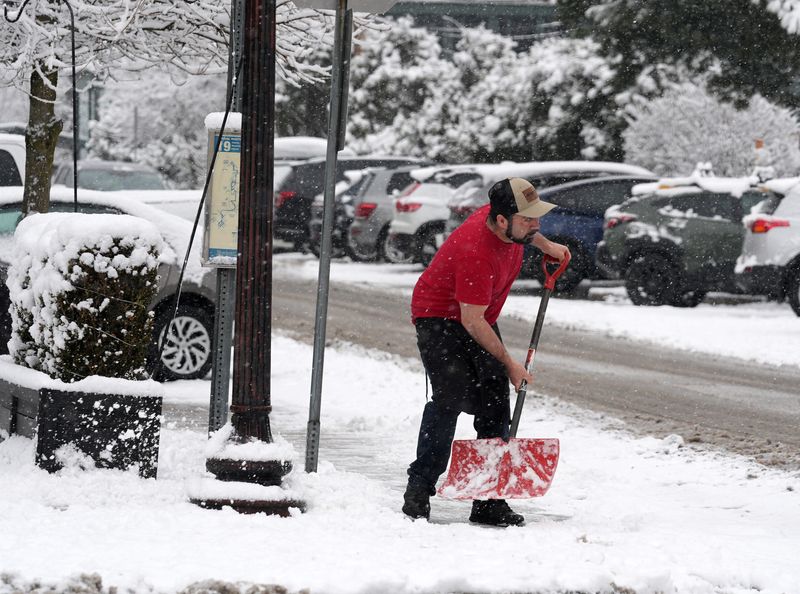 A workers clearing snow on a sidewalk along Katonah Ave in downtown katonah Jan. 17, 2026.