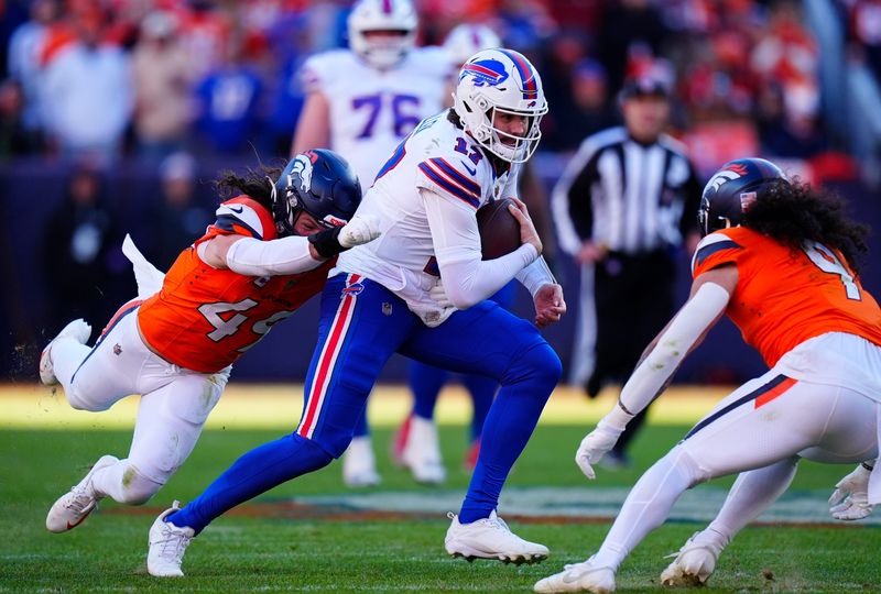Jan 17, 2026; Denver, CO, USA; Buffalo Bills quarterback Josh Allen (17) runs against Denver Broncos linebacker Alex Singleton (49) and safety Talanoa Hufanga (9) during the second quarter of an AFC Divisional Round playoff game at Empower Field at Mile High. Mandatory Credit: Ron Chenoy-Imagn Images
