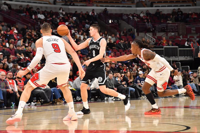 Jan 18, 2026; Chicago, Illinois, USA; Brooklyn Nets guard Egor Demin (8) passes against Chicago Bulls center Nikola Vucevic (9) during the second half at United Center. Mandatory Credit: Patrick Gorski-Imagn Images