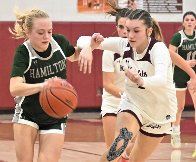 Hamilton Emerald Knight Rihana Dye (left) handles the ball under pressure from Frankfort-Schuyler Maroon Knight Isabella Paragi during Thursday's game.