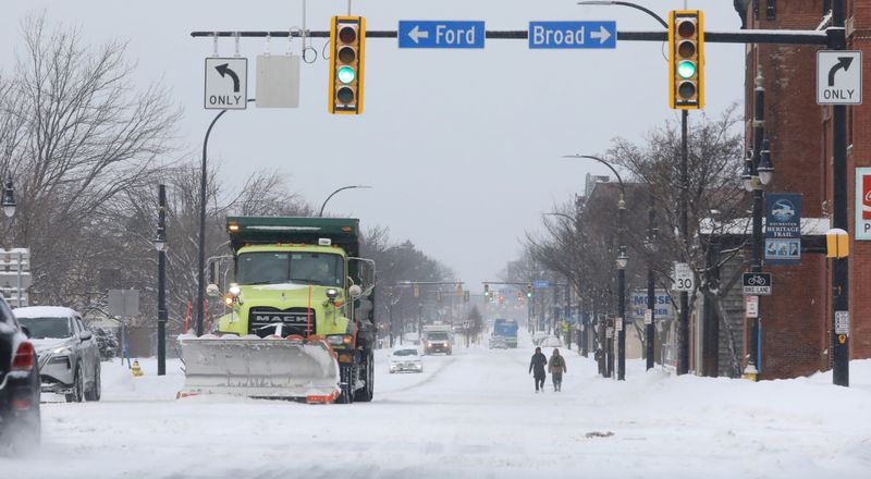 Plows were out in force as both drivers and pedestrians found ways through the snow along W Main Street in Rochester Monday, Jan. 26, 2026. The storm, which started on Sunday, dumped over a foot of snow in parts of the Rochester region by the time it was done early Monday morning.