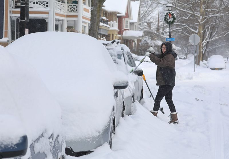 Paige Webb, Rochester, digs her car out from under nearly a foot of snow in the Park Avenue Neighborhood in Rochester Monday, Jan. 26, 2026. The storm, which started on Sunday, dumped over a foot of snow in parts of the Rochester region by the time it was done early Monday morning.