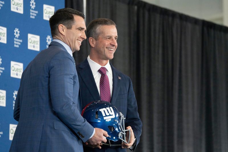 General Manager Joe Schoen and new Giants head coach John Harbaugh hold a NY Giants helmet during a press conference welcoming Harbaugh at the Quest Diagnostics Training Center in East Rutherford on Tuesday, Jan. 20, 2025.