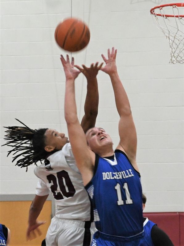 Frankfort-Schuyler Maroon Knight Marquis Grimes and Dolgeville Blue Devil Kaden Murphy (from left) reach for a rebound during Friday's game.