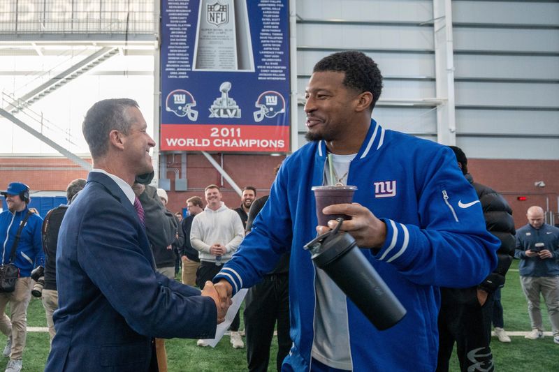 New Head Coach John Harbaugh shakes hands New York Giants quarterback Jameis Winston during a press conference introducing Harbaugh at the Quest Diagnostics Training Center in East Rutherford on Tuesday, Jan. 20, 2025.