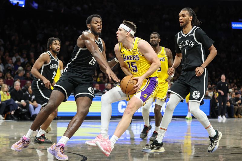 Feb 3, 2026; Brooklyn, New York, USA; Los Angeles Lakers guard Austin Reaves (15) looks to drive past Brooklyn Nets center Day'ron Sharpe (20) in the fourth quarter at Barclays Center. Mandatory Credit: Wendell Cruz-Imagn Images