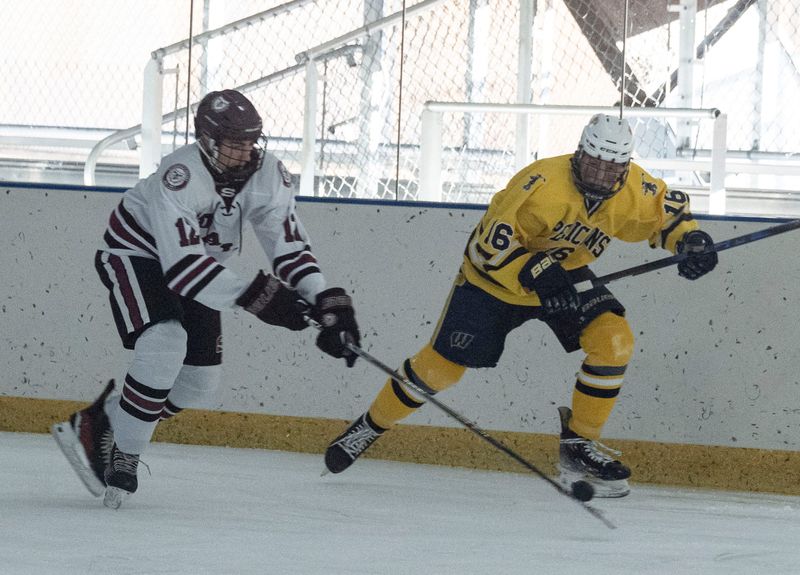 Daniel Kuyumjhian of Scarsdale battles Owen Wierstra of Pelham for the puck during a varsity hockey game at the E J Murray Memorial Skating Center in Yonkers Feb. 4, 2026. Pelham defeated Scarsdale 5-2.