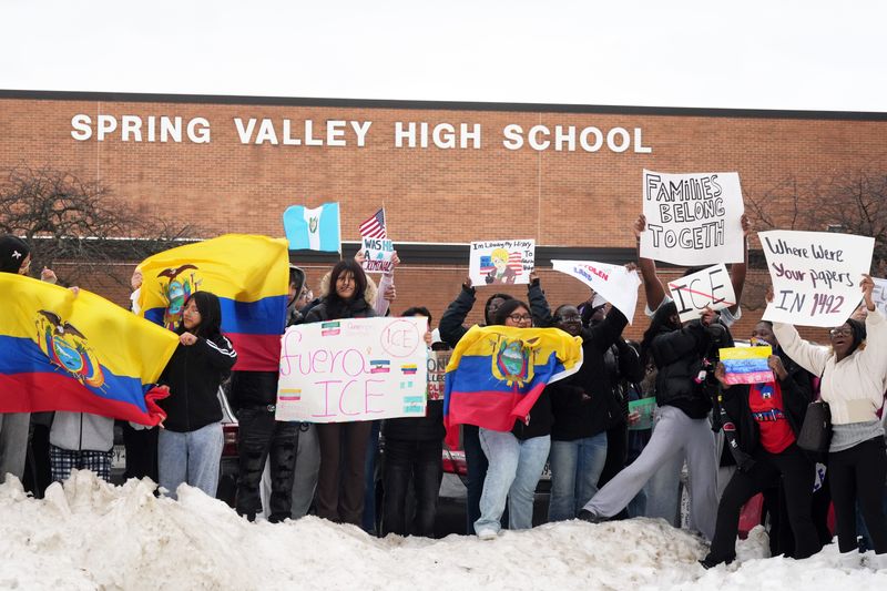 Students holds signs and flags after walking out of Spring Valley High School in protest of recent immigration crackdowns in Rockland County and beyond Feb. 11, 2026 in Spring Valley.