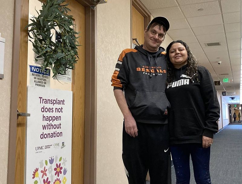 Adam and Zee Hoover stand outside UPMC Hamot's transplant services medical office, 300 State St. Adam Hoover underwent his second kidney transplant in December.