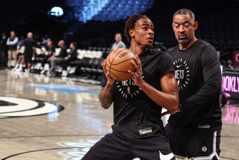 Oct 27, 2024; Brooklyn, New York, USA; Brooklyn Nets center Nic Claxton (33) warms up with assistant coach Juwan Howard prior to the game against the Milwaukee Bucks at Barclays Center. Mandatory Credit: Wendell Cruz-Imagn Images