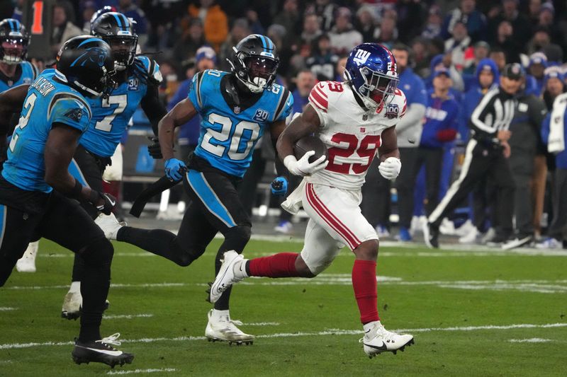 Nov 10, 2024; Munich, Germany; New York Giants running back Tyrone Tracy Jr. (29) carries the ball on a 32-yard touchdown run against the New York Giants in the second half during the 2024 NFL Munich Game at Allianz Arena. Mandatory Credit: Kirby Lee-Imagn Images