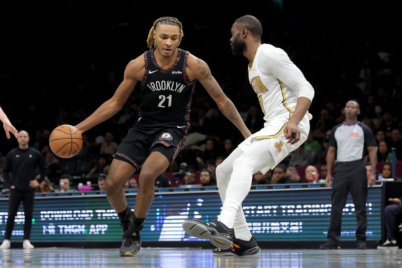 Jan 23, 2026; Brooklyn, New York, USA; Brooklyn Nets forward Noah Clowney (21) drives to the basket against Boston Celtics guard Jaylen Brown (7) during the third quarter at Barclays Center. Mandatory Credit: Brad Penner-Imagn Images