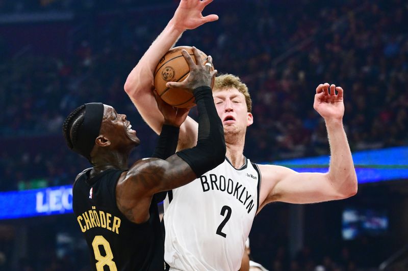 Feb 19, 2026; Cleveland, Ohio, USA; Cleveland Cavaliers guard Dennis Schroder (8) drives to the basket against Brooklyn Nets forward Danny Wolf (2) during the second half at Rocket Arena. Mandatory Credit: Ken Blaze-Imagn Images
