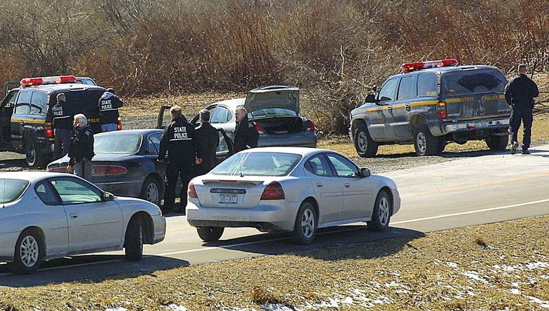 3/2/2006, 1A: Law enforcement officers converge on the scene of a fatal shooting of New York state Trooper Andrew J. Sperr along Lowe Road in the Town of Big Flats on March 1, 2006.