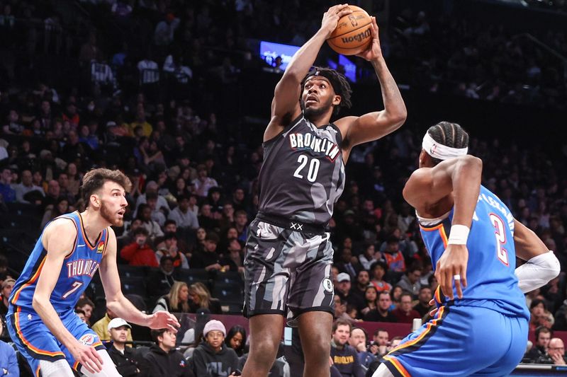 Feb 26, 2025; Brooklyn, New York, USA; Brooklyn Nets center Day'Ron Sharpe (20) looks to drive past Oklahoma City Thunder forward Chet Holmgren (7) and guard Shai Gilgeous-Alexander (2) in the third quarter at Barclays Center. Mandatory Credit: Wendell Cruz-Imagn Images
