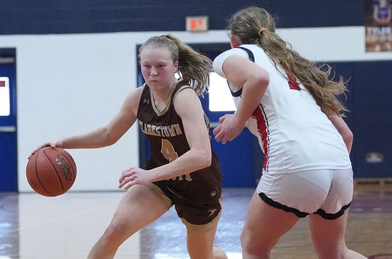 Clarkstown South's Carley Voce (4) drives on Fox Lane's Morgan Clinton (1) during the Section 1 Class AA girls basketball playoff game at Byram Hills High School in Armonk on Saturday, February 21, 2026. Clarkstown South won 49-47.