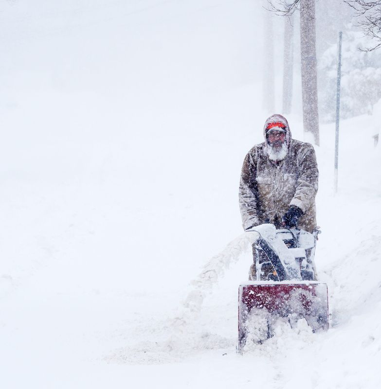 Jay Johnson is covered in snow as he clears the sidewalk outside his Center Street home in Brewster, New York Feb. 23, 2026.