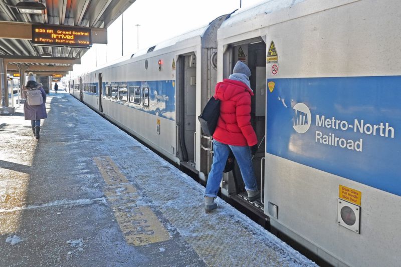 A commuter boards a Grand Central bound train at the Croton Harmon Station Feb. 24, 2026 in Croton-on-Hudson. Metro-North is operating a Saturday schedule with enhanced service on the Hudson, Harlem and New Haven lines, the day after a blizzard slammed the region.